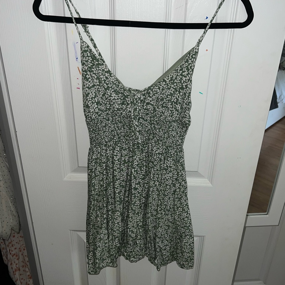 Green mini dress in good condition with white flowers